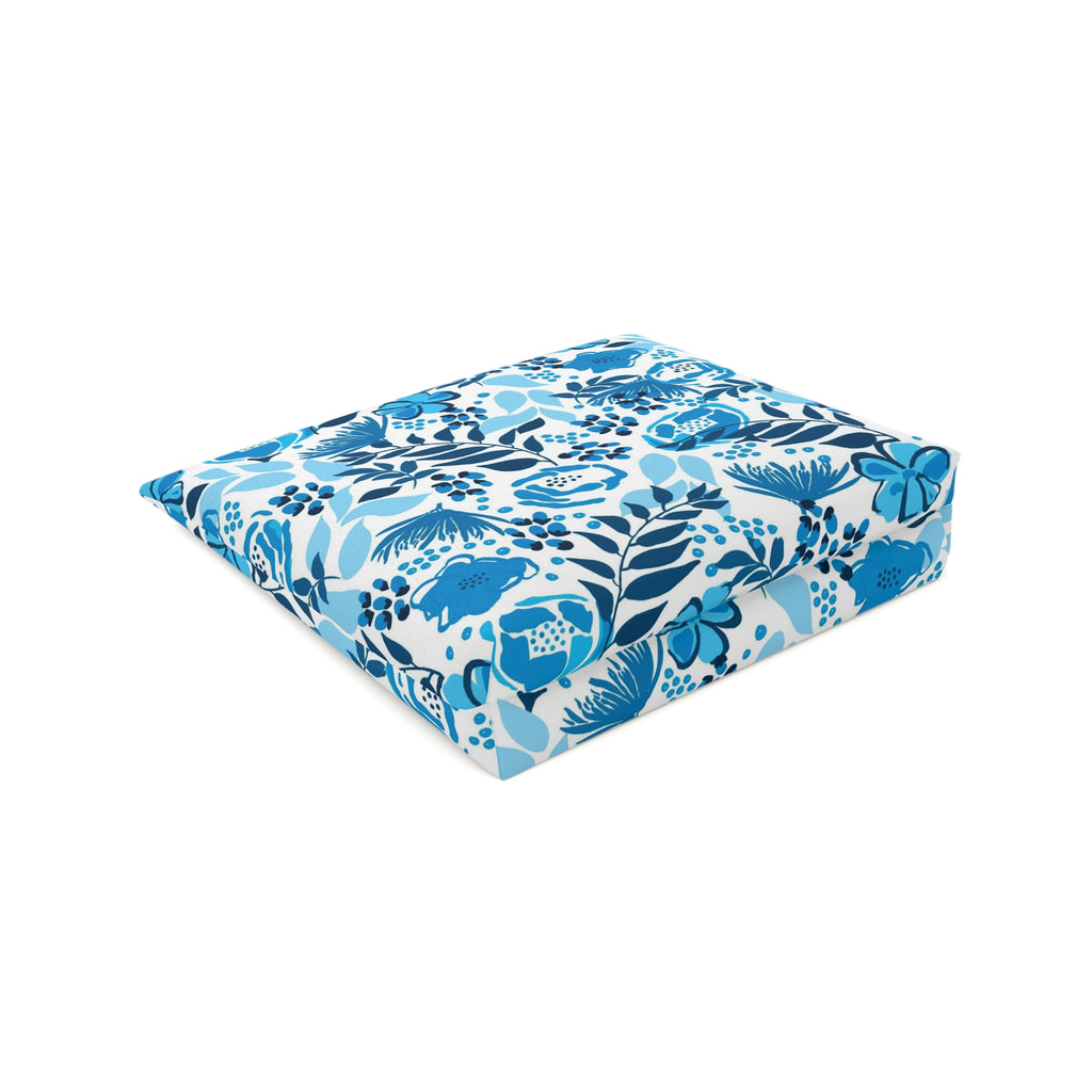 Cosmetic bag with white zipper and a blue floral design with flowers and leafy stems on a white background and laying on it's side to show the  rectangle shaped bottom