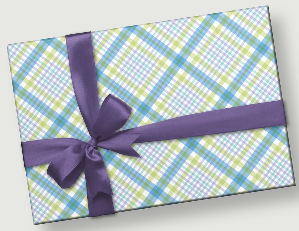 This is a rectangular gift with a purple satin bow. The gift wrap pattern is a hand designed tartan of blue, green and purple.