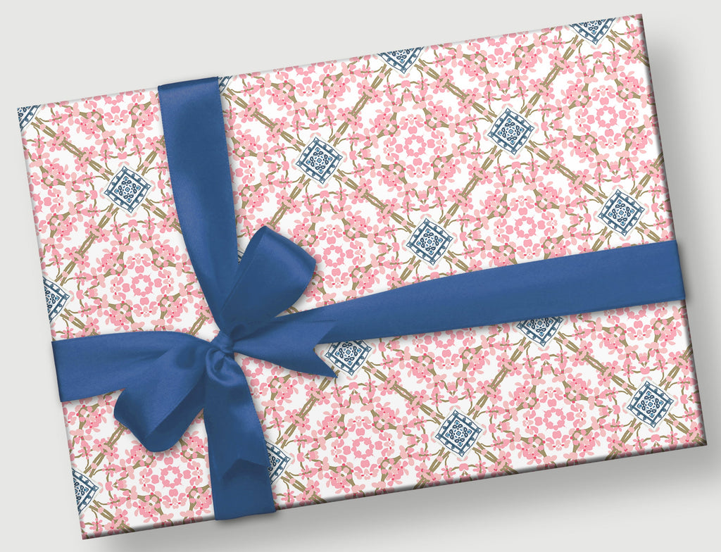 This is a gift with a navy blue bow.  It is hand-drawn Cherry Blossoms Geometric with pink cherry blossoms in a circle and a blue and white motif at the center of delicate brown branches crossing. It has a chinoisorie look.