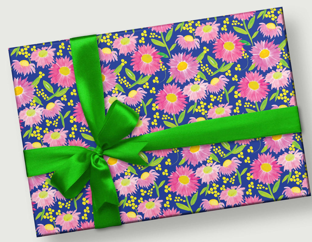 These hand-painted watercolor delicate pink coneflowers (yellow center and pink petals with green stems and navy blue background) are on a gift with a kelly green ribbon and bow.