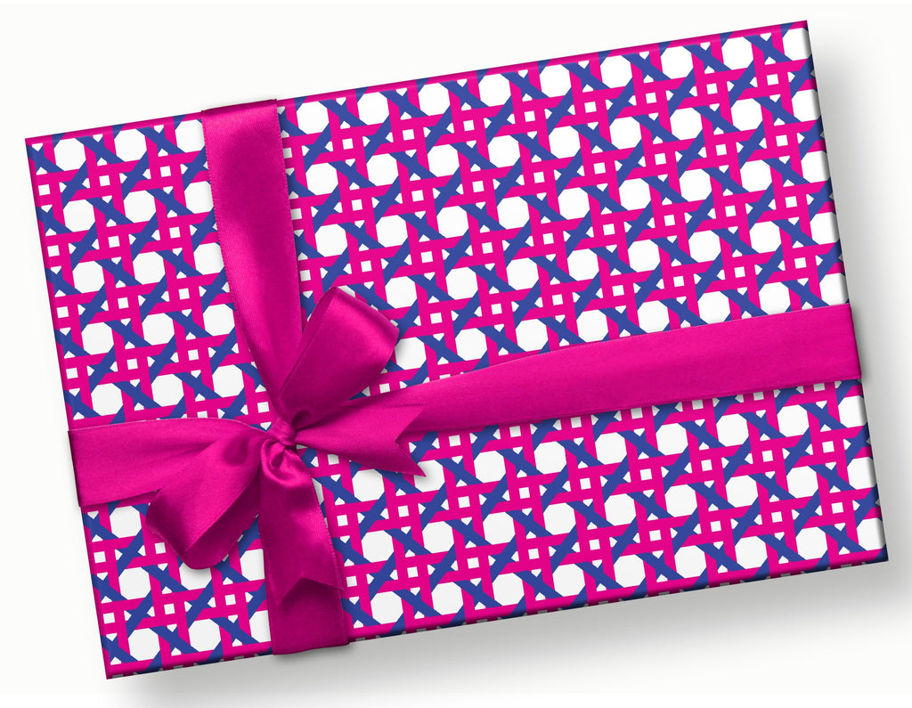 This is a rectangular gift with a hot pink satin bow. The gift wrap pattern is a hand designed caning pattern with intricate geometric designs in shades of pink and navy blue.